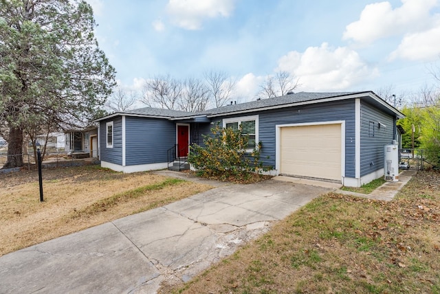 ranch-style house with a garage, gas water heater, and a front lawn