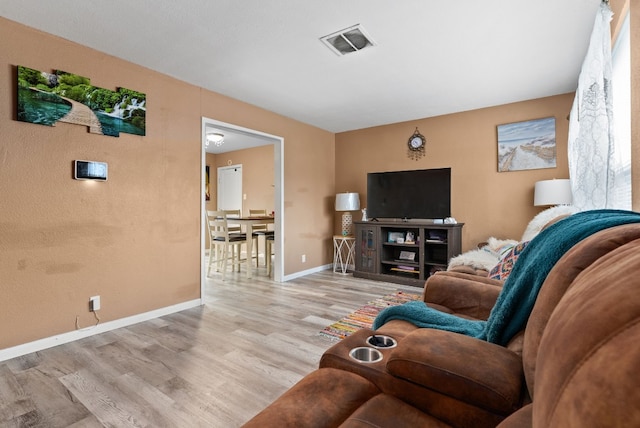 living room with light hardwood / wood-style floors