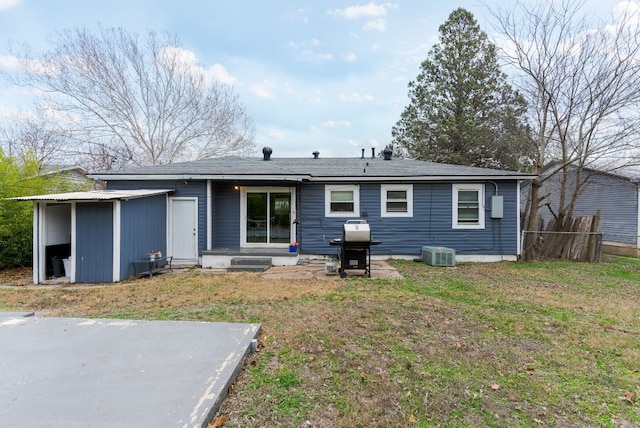 back of house with cooling unit, a patio area, and a lawn