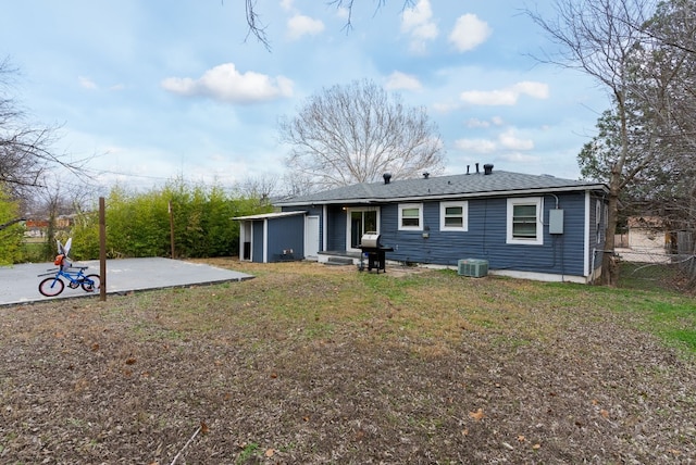 back of house with central AC unit, a yard, and a patio area