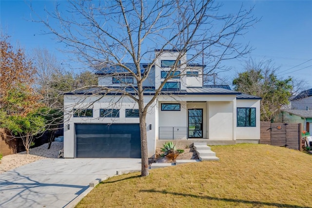 view of front of property featuring a garage and a front lawn