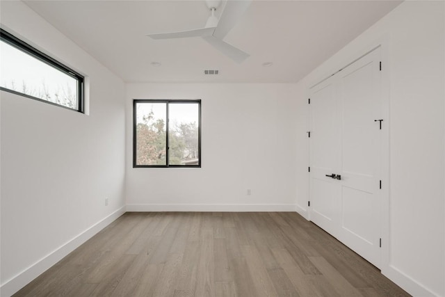 unfurnished room featuring ceiling fan and light wood-type flooring