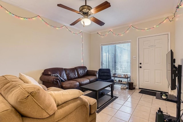 living room with light tile patterned floors, ornamental molding, and ceiling fan