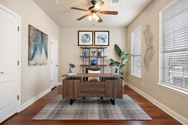 home office with dark wood-type flooring and ceiling fan