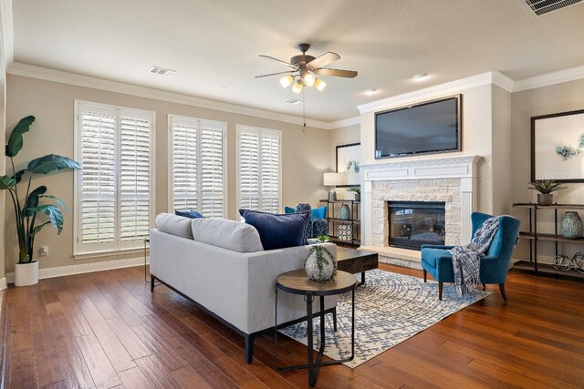 living room with dark wood-type flooring, a healthy amount of sunlight, and crown molding