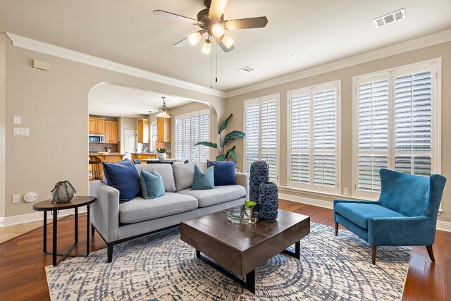 living room with crown molding and hardwood / wood-style flooring