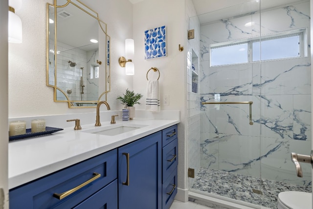 bathroom with vanity, toilet, and walk in shower