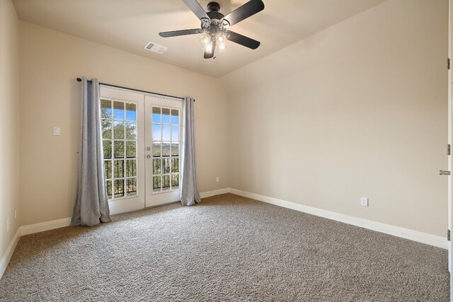 empty room with vaulted ceiling, carpet, ceiling fan, and french doors