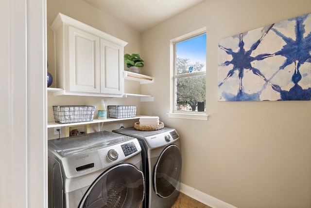 laundry room with washer and clothes dryer and cabinets