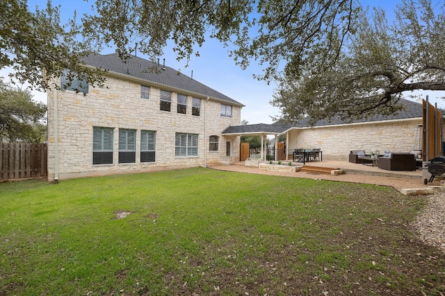 rear view of property featuring an outdoor living space, a yard, and a patio area