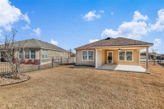 rear view of house featuring a yard, ceiling fan, and a patio area