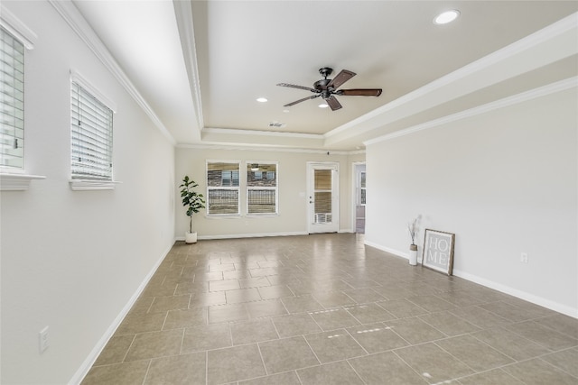 unfurnished room with crown molding, a healthy amount of sunlight, ceiling fan, and a tray ceiling