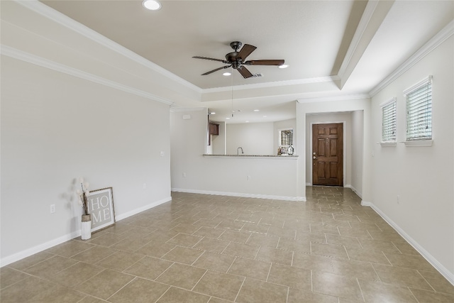 unfurnished living room featuring crown molding, ceiling fan, and a tray ceiling