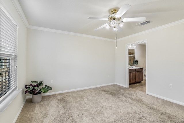 carpeted spare room with crown molding and ceiling fan