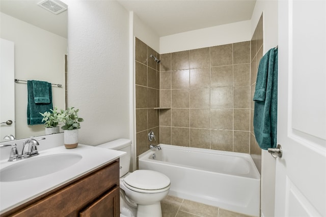 full bathroom featuring tiled shower / bath, vanity, toilet, and tile patterned flooring