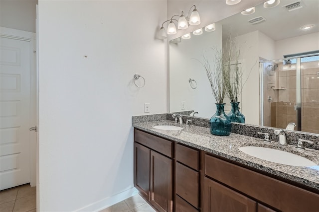 bathroom with tile patterned flooring, vanity, and a shower with shower door