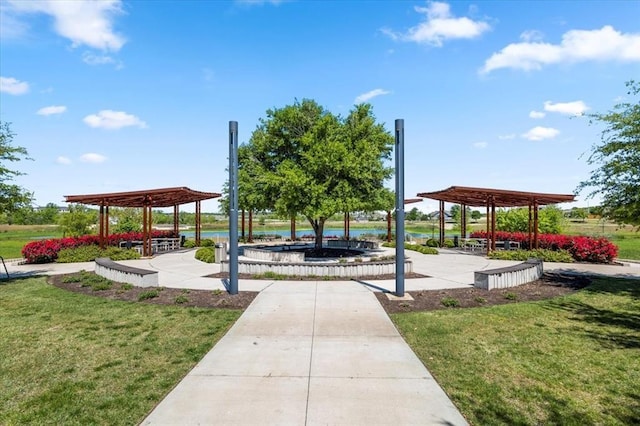 view of community with a gazebo, a water view, and a lawn