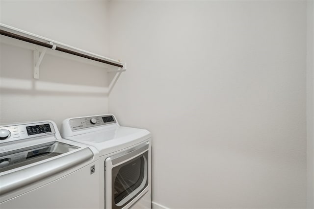 laundry room featuring washing machine and clothes dryer