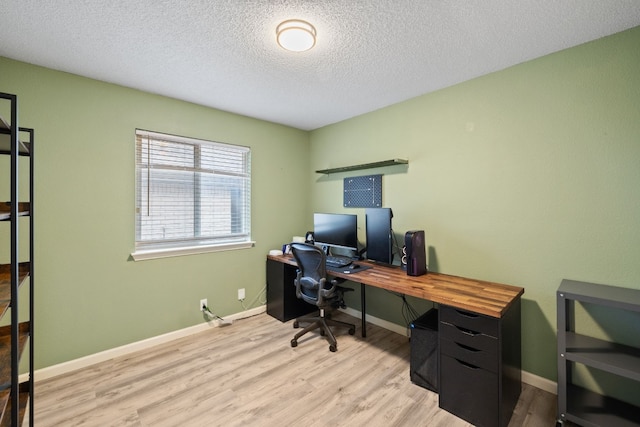 office area with a textured ceiling and light wood-type flooring