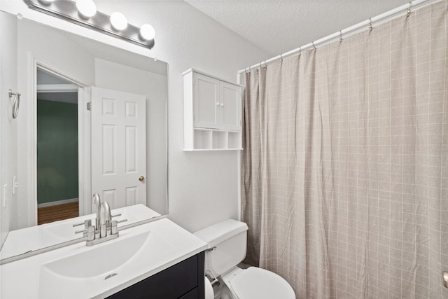 bathroom with a shower with curtain, vanity, a textured ceiling, and toilet