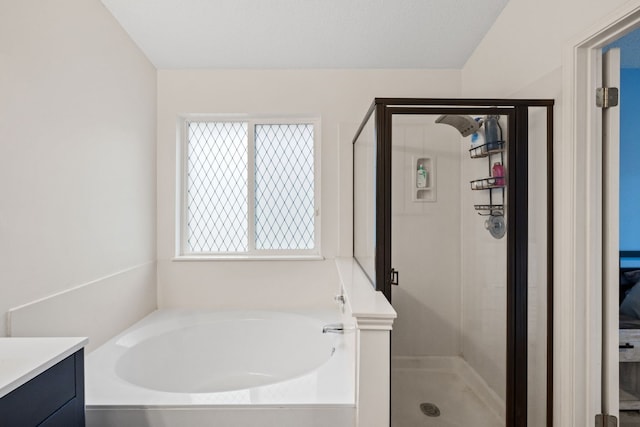 bathroom with vanity and separate shower and tub