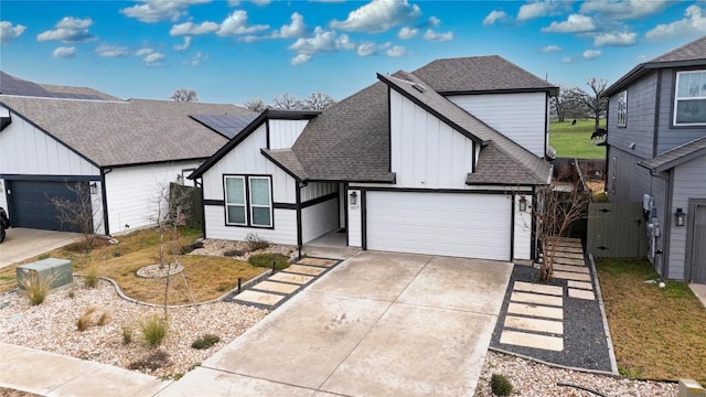 view of front of house with a garage, driveway, a shingled roof, and board and batten siding