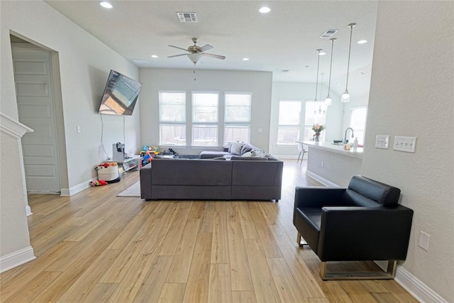 16817 Adoro Dr, Manor, TX 78653 - living area with light wood-style floors, ceiling fan, recessed lighting, and baseboards