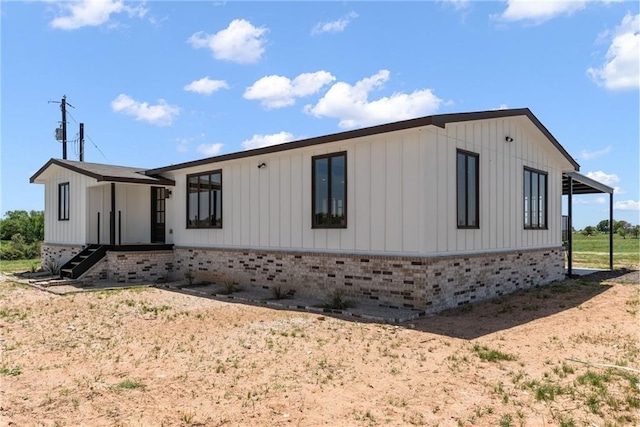 185 Eely Rd, Mcdade, TX 78650 - view of front of home with board and batten siding and brick siding