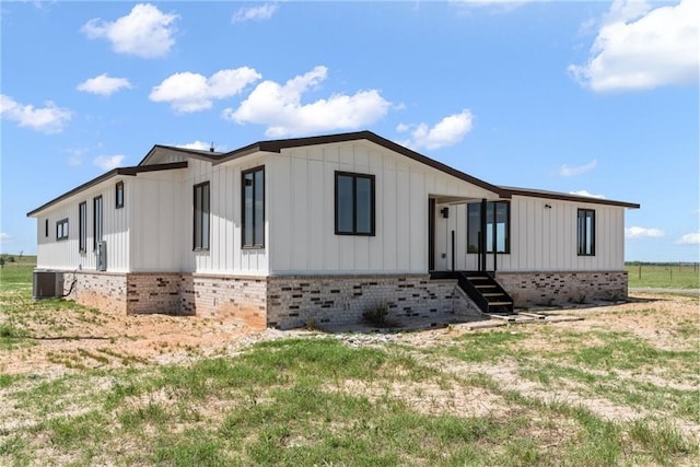 185 Eely Rd, Mcdade, TX 78650 - view of front of property featuring central AC unit and brick siding