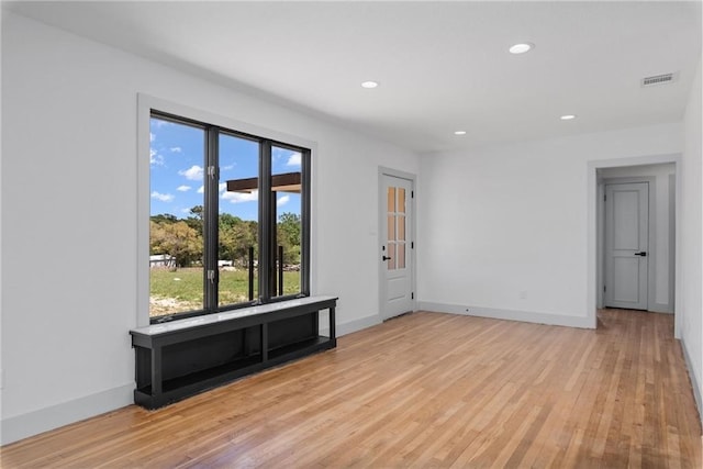 unfurnished room with light hardwood / wood-style floors