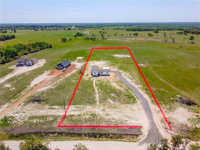 birds eye view of property with a rural view