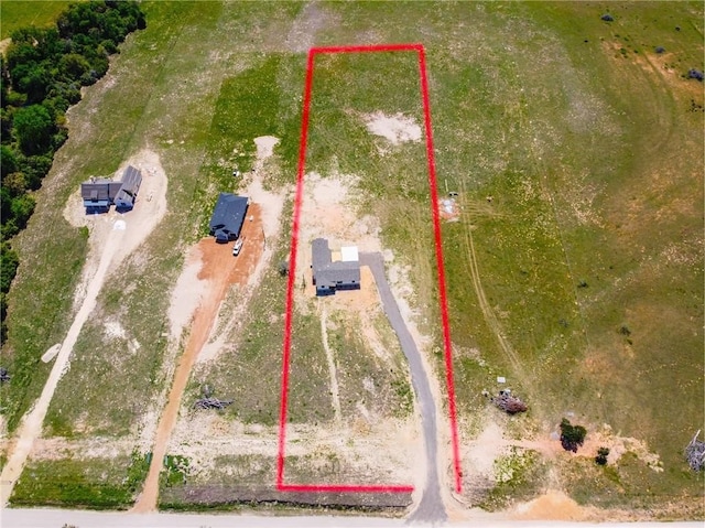 birds eye view of property featuring a rural view