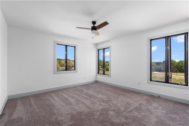 carpeted spare room with ceiling fan