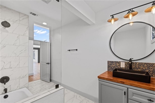 bathroom featuring shower / bathtub combination and vanity