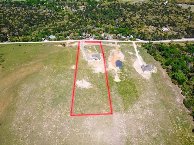 birds eye view of property with a rural view