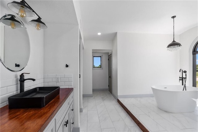 bathroom featuring vanity and a tub to relax in