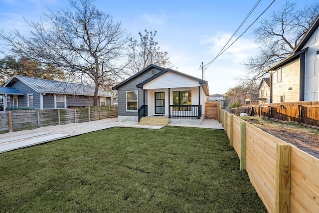 view of front of property with a front yard and a porch