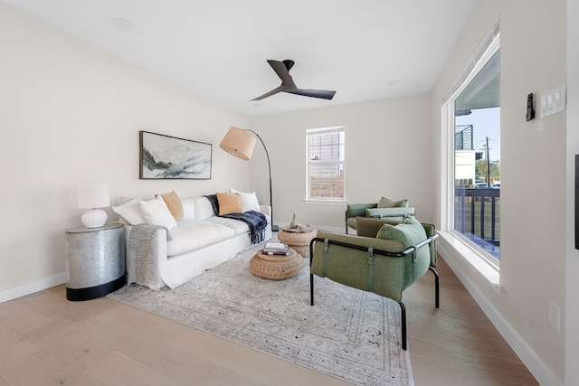 living room with light hardwood / wood-style floors and ceiling fan