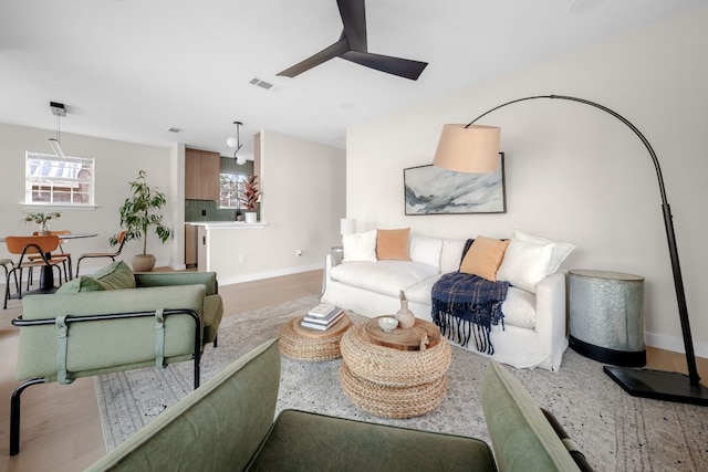 living room featuring ceiling fan and light hardwood / wood-style floors