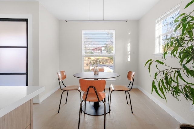 dining space with light hardwood / wood-style flooring