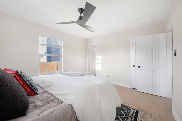 bedroom with light hardwood / wood-style flooring and ceiling fan