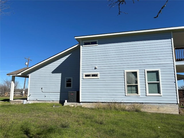 rear view of house featuring a lawn