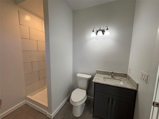 bathroom with vanity, walk in shower, tile patterned floors, and toilet