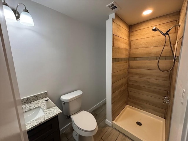 bathroom with vanity, walk in shower, and toilet