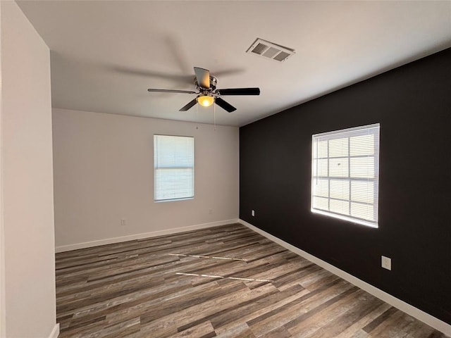 spare room with ceiling fan and dark hardwood / wood-style floors