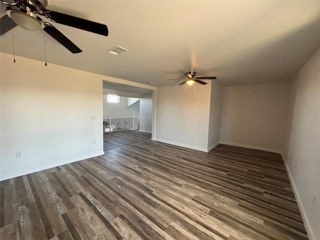 unfurnished room with dark hardwood / wood-style flooring