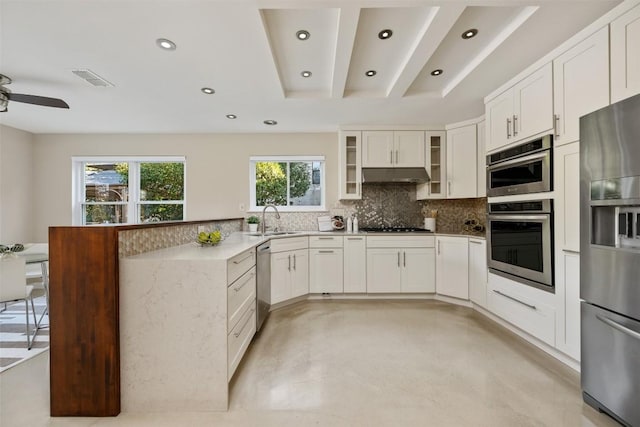 kitchen featuring sink, tasteful backsplash, ceiling fan, stainless steel appliances, and white cabinets