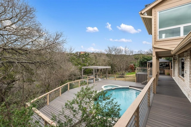 view of swimming pool featuring an outdoor hot tub, a gazebo, and a wooden deck