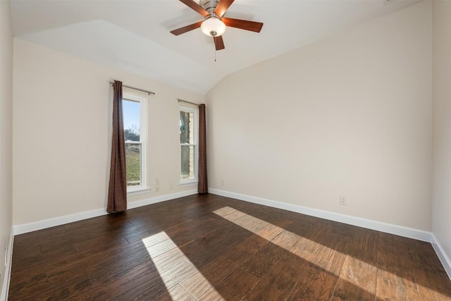 spare room with vaulted ceiling, dark hardwood / wood-style floors, and ceiling fan