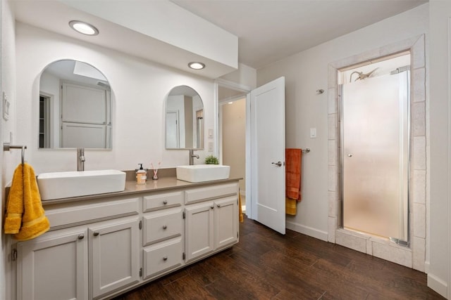 bathroom with vanity, an enclosed shower, and hardwood / wood-style floors